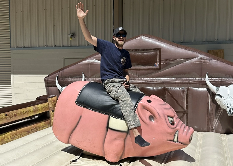 Boss Hog mechanical pig ride rental bucking at an outdoor Florida event