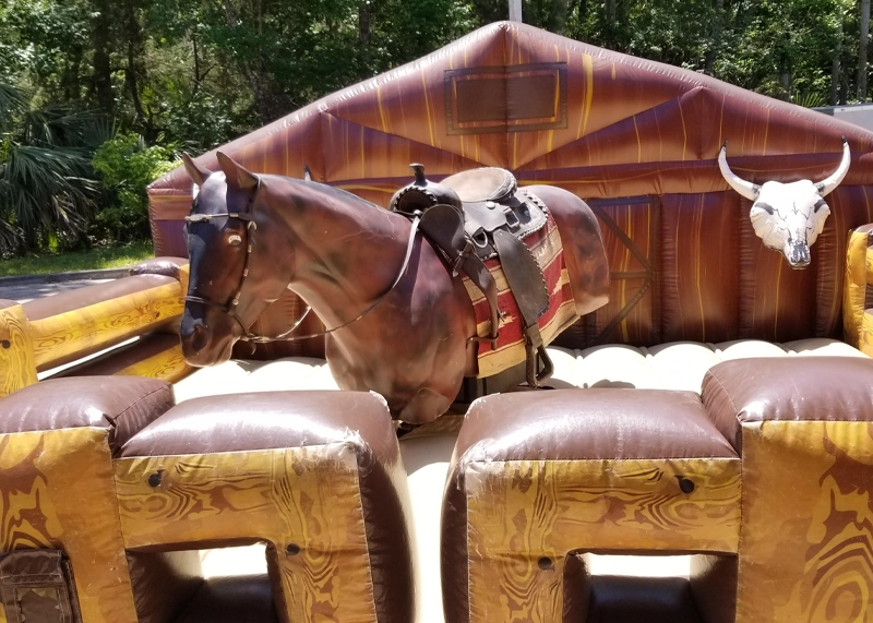 Big Bucking Bronco mechanical horse ride rental outfitted with western gear