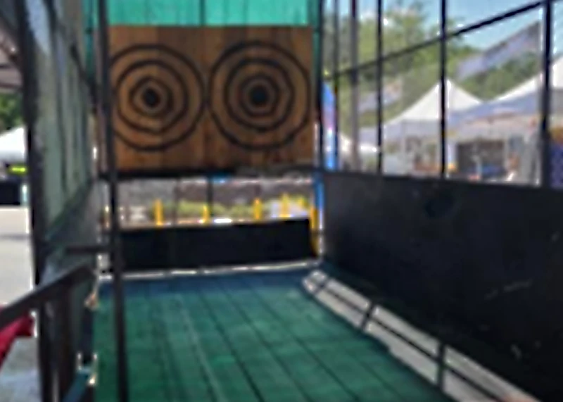 Mobile axe throwing trailer rental with coached lanes at a Florida corporate event