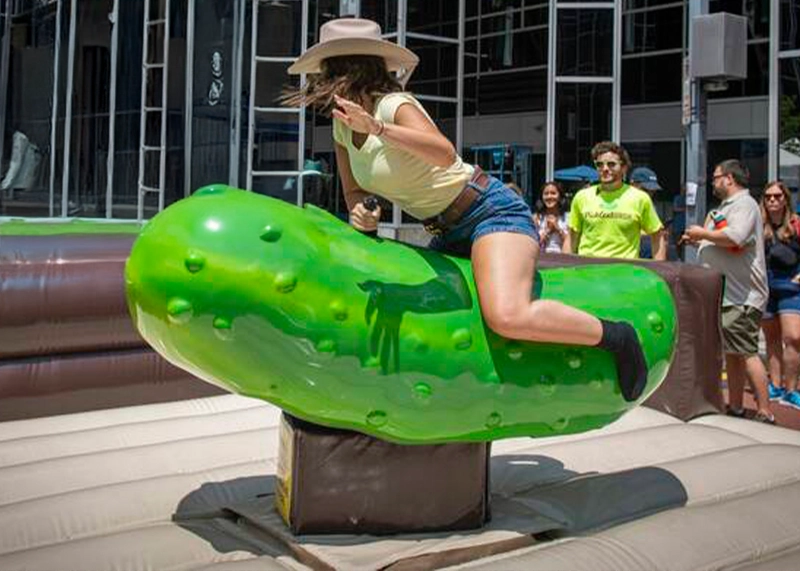Wild Dill mechanical pickle ride rental with inflatable bounce house corral